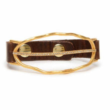 Load image into Gallery viewer, The Open Leaf W Crystal Line Leather Bracelet features supple Italian leather and an irregular gold metal oval adorned with Austrian crystals. It secures with two gold snap buttons, adding elegance to any outfit.
