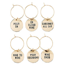 Load image into Gallery viewer, The Gold Wine Charms in Pine Box - Wine Tasting Daily set includes six playful charms, ideal for gifts. Featured phrases: &quot;POUR ON,&quot; &quot;ON CLOUD WINE,&quot; &quot;CABERNET ALL DAY,&quot; &quot;NINE TO WINE,&quot; &quot;POUR DECISIONS,&quot; and &quot;WINE SNOB.&quot; Each disk is elegantly attached to a hoop.
