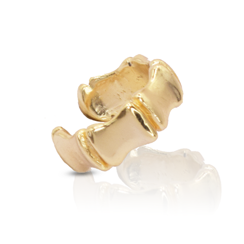 Introducing the Polished Connection Plate Ring, a stunning piece crafted from 24-karat gold. This ring showcases a unique scalloped design with raised, wavy segments that beautifully reflect light, casting vibrant highlights and shadows. Photographed against a white background, it features a subtle reflection beneath it.