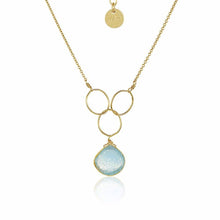 Load image into Gallery viewer, The Cassiopeia Necklace showcases a stunning design with a pendant of three interlocking gold hoops and a translucent blue gemstone elegantly suspended from the bottom hoop. It features a delicate, adjustable gold-filled chain, complete with a small circular gold tag engraved near the clasp.
