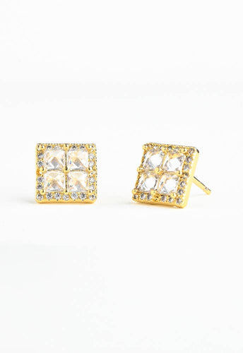 The Dignity Zircon Stud Earrings are square-shaped 14K gold pieces featuring four clear gemstones arranged in a 2x2 grid, surrounded by tiny, sparkling stones. Hypoallergenic and elegantly showcased upright on a white background, these earrings provide both style and comfort.