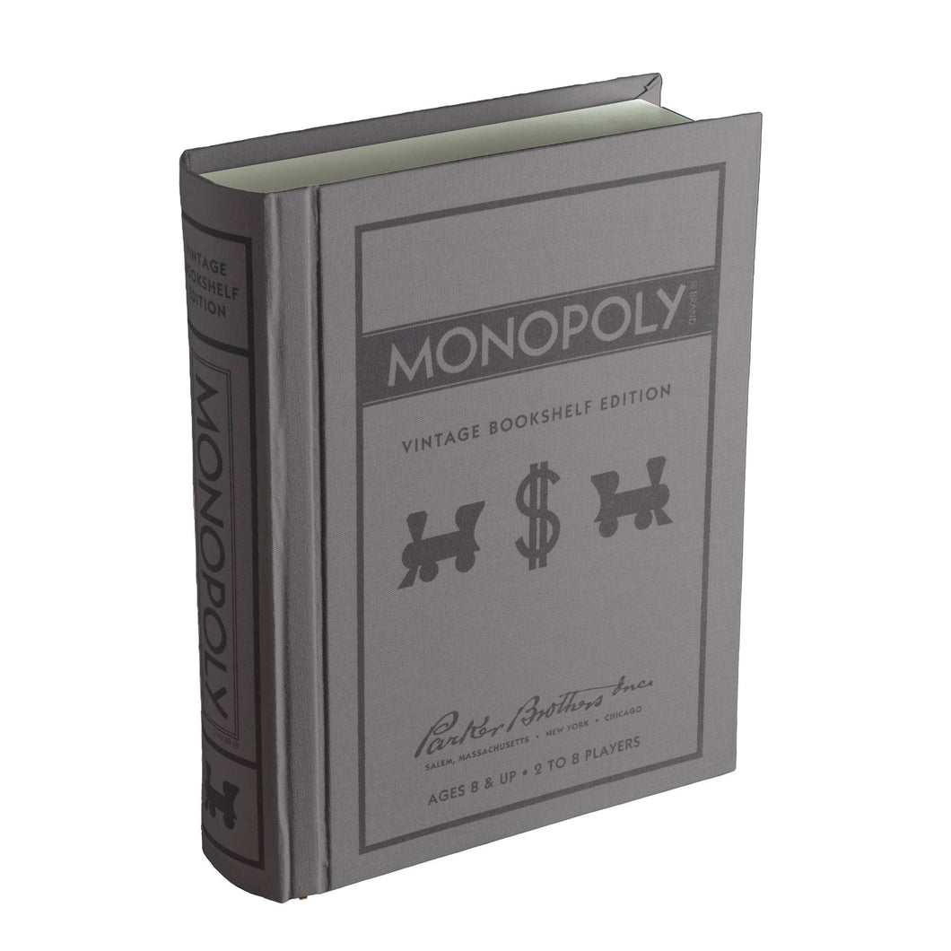 The Monopoly Vintage Bookshelf Edition, designed to resemble a vintage book, includes premium game components. This gray box adorned with black text and illustrations features train tokens and a dollar sign. Ideal for ages 8 and up and supporting 2 to 8 players, it is produced by Parker Brothers Inc.