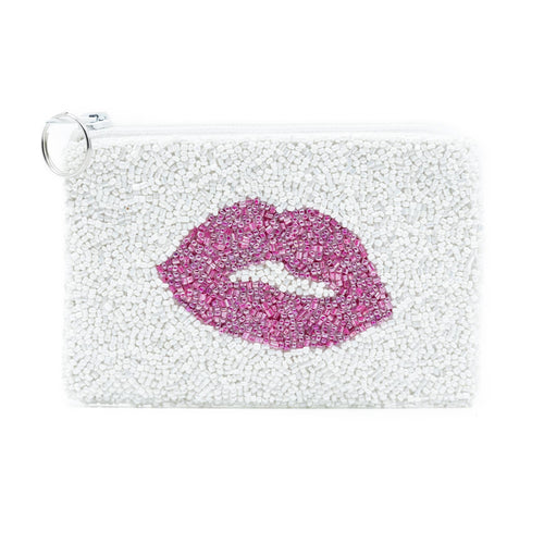 The Valentine’s Beaded Coin Purse exemplifies timeless elegance with a pink lips design on its white surface. Crafted from exquisite beads, it features a silver key ring on the zipper pull, showcasing Indian handcrafted artistry.