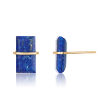 Load image into Gallery viewer, Close-up of the Lapis Studs, showcasing their handcrafted rectangular lapis lazuli stones flecked with gold. These vibrant blue studs are set in a simple 14k gold-filled frame, and a side view reveals a thin gold post. The polished stones reflect light beautifully against the clean white backdrop.
