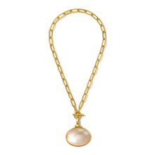 Load image into Gallery viewer, The Diana V. Pendant Necklace features elongated gold chain links and a large, smooth, mother of pearl-like round pendant set in a gold bezel. It closes with a toggle clasp, creating an elegant and modern look against a white background.
