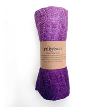 Load image into Gallery viewer, A purple scarf with a woven look is wrapped in a brown band labeled &quot;rubyzaar Wabi Silk Scarf.&quot; Made of sustainable mulberry silk on a Thai loom, its shades gracefully blend from light to dark purple.
