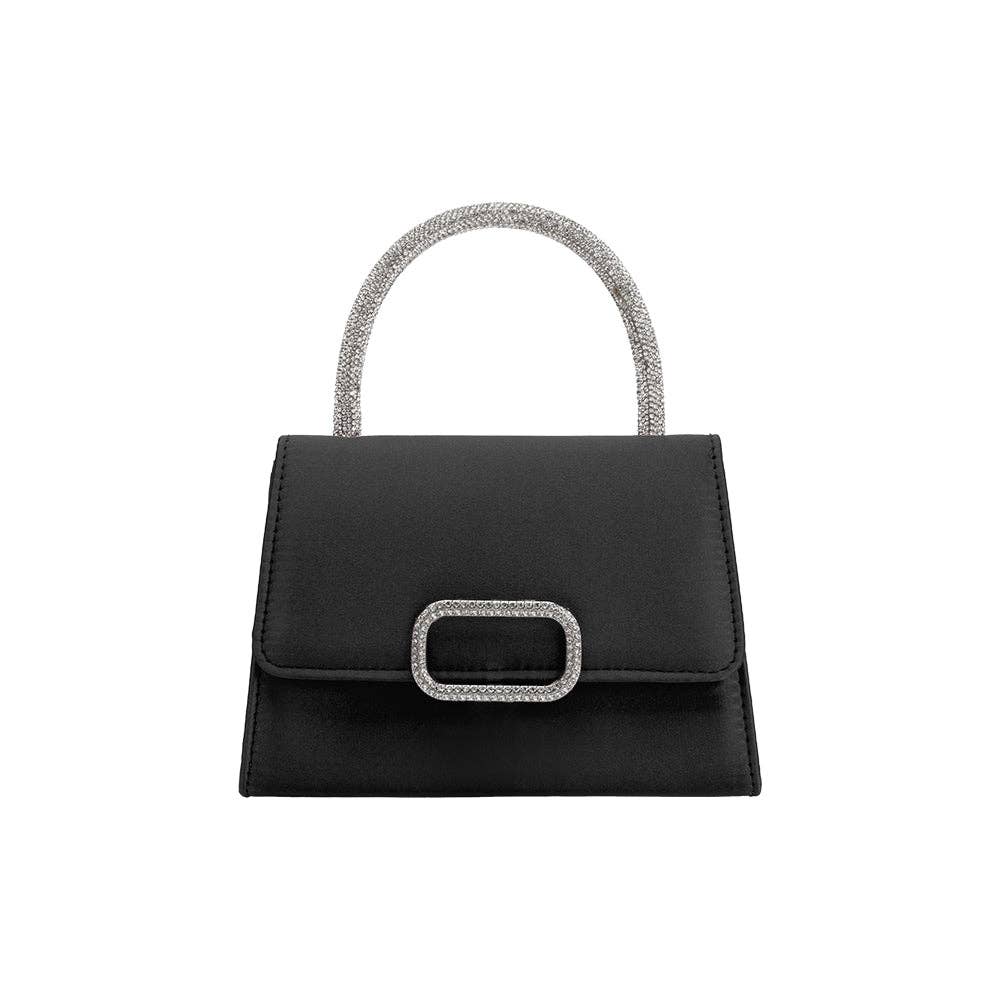 The Sadie Satin Top Handle Bag is a small, elegant, black handbag with a rectangular shape and flap closure, highlighted by a metallic buckle. Its silver crossbody strap adds shimmer and style to its minimalist design, making it both chic and functional.