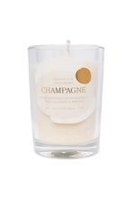 Load image into Gallery viewer, The Champagne Candle 6 oz from the Sparkling Collection is a clear glass candle with a circular tag listing scents: peony, bergamot, effervescence, peach blossom, and brioche. Handmade in Charleston, this minimalist white candle enhances any celebratory occasion.
