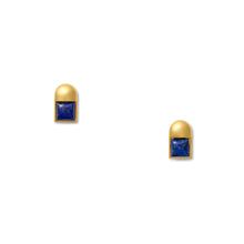 Load image into Gallery viewer, The Baby Cubism Earrings are a pair of sleek, post earrings that showcase square blue gemstones stylishly set in a 14 karat gold frame with rounded tops. Displayed against a plain white background, they feature hypoallergenic silicone backs for added comfort.
