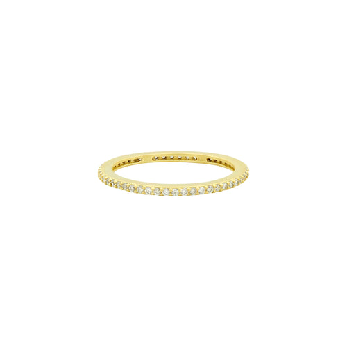 The All Pavé Stack Ring features a thin 14K gold band elegantly adorned with small, sparkling diamonds that encircle its entirety. These diamonds are evenly set in a single row along the outer surface, forming a continuous line of shimmer. Its smooth, polished finish enhances the ring's elegance and simplicity.