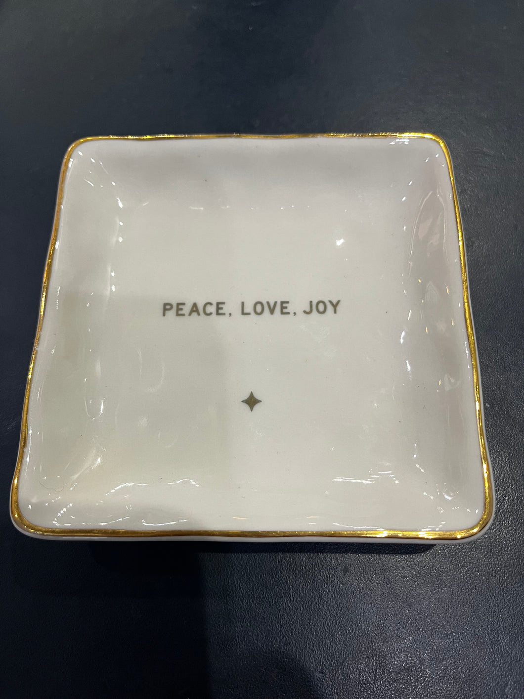 The Holiday Trinket or Soap Dish is a square, white keepsake dish with gold trim that displays the words 