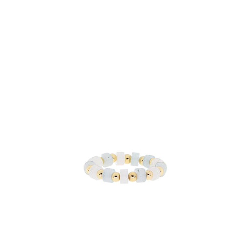 Introducing the Stone Disc Stretch Ring, a minimalist piece that showcases alternating small white beads and gold ball beads. The design is beautifully arranged to create a simple yet elegant look against a plain white background.