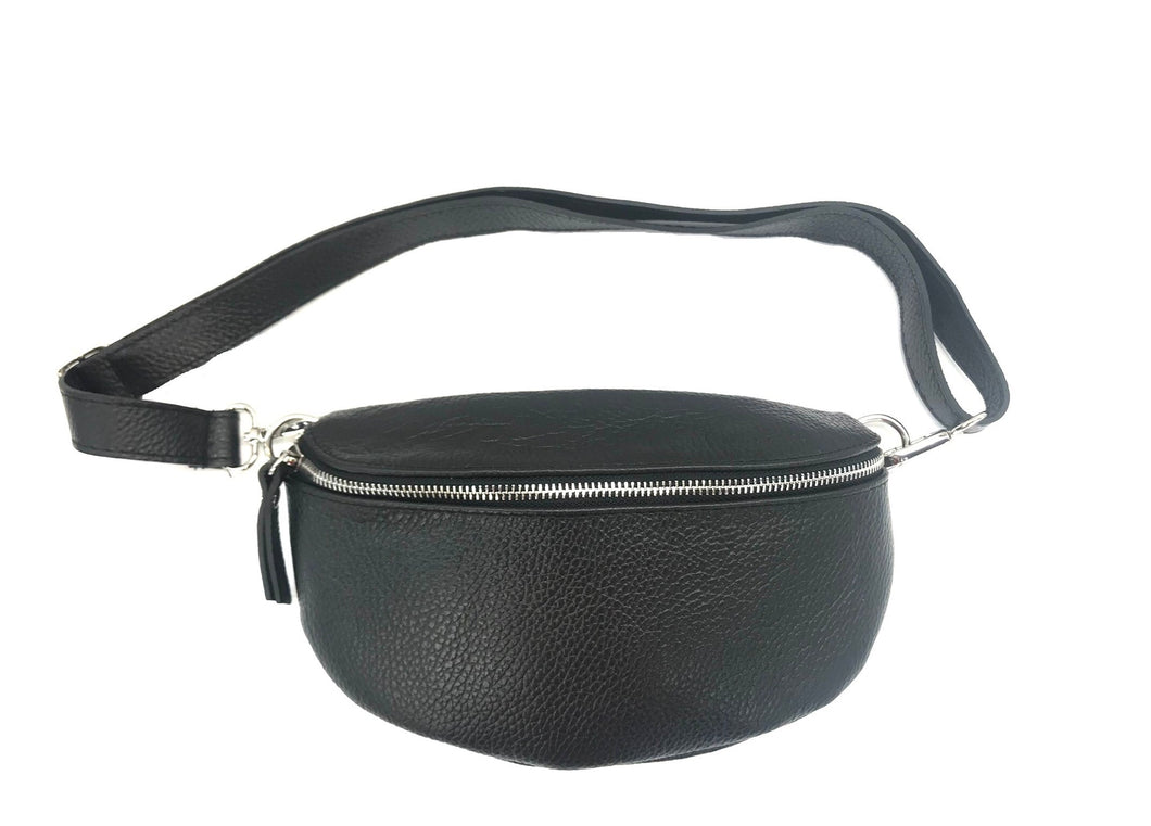 The Leather Bum Bag, in a black textured leather design and circular shape, showcases a zipper closure along the top. It measures 10 x 6 x 2 inches and includes an adjustable strap with a silver zipper and matching pull tab against a plain white background.