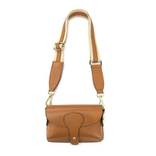 Load image into Gallery viewer, This Mini Crossbody - Leather bag, crafted from genuine leather in a deep brown hue, features a long adjustable strap. The curved flap closure is adorned with a brass button and subtle light brown accents for added elegance. Its brass hardware beautifully complements the smooth texture, making it perfect as a stylish stadium bag.
