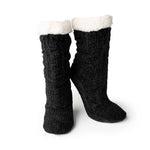 Load image into Gallery viewer, Introducing the Beyond Soft Slipper Socks, a pair of stylish knitted black boots featuring a textured pattern and a fluffy white fleece lining at the top. These cozy boots, reminiscent of cable knit slipper socks, stand upright against a plain white background to highlight their chic design with non-slip soles for enhanced comfort.
