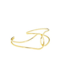 Load image into Gallery viewer, Introducing the Gold Twist Cuff: a sophisticated bracelet with an abstract, flowing design. Measuring 6 inches in circumference, this piece features smooth, intersecting loops that form an elegant and modern aesthetic. Its open structure and polished gold finish contribute to its refined and stylish appearance.
