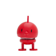 Load image into Gallery viewer, This Hoptimist Bumble, a charming nod to Danish design history, features a red round head and body on two legs. With black oval eyes and a pointed nose, it boasts an antenna-like top. A coiled spring connects the head to the body, making it perfect for adding playful bounce to your home decor.
