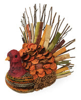 The Jerry Pinecone & Husk Thanksgiving Turkey is perfect for autumn decoration. This charming tabletop piece features a body crafted from pine cones and a tail adorned with sticks and colorful leaves. Its textured, red-painted head adds detailed elegance, making it a festive addition to your home.