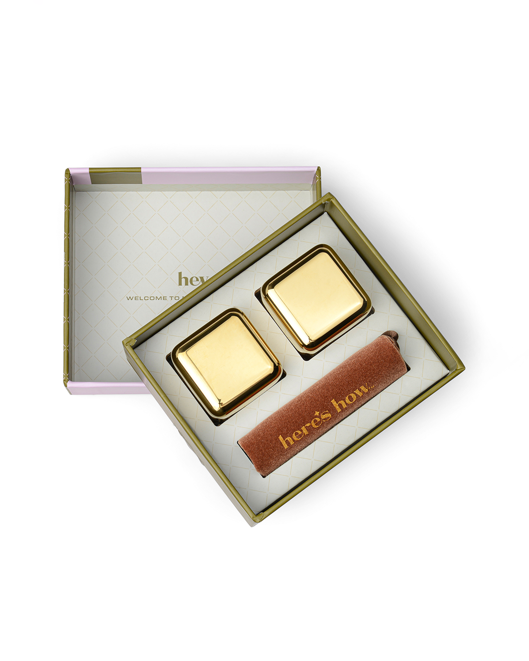 Unbox the elegant gold and pink packaging that houses The Jupiter Cocktail Chillers in Gold - Set of 2, along with a cylindrical brown accessory featuring 