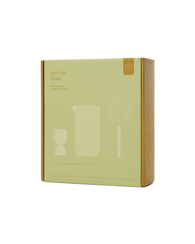 Box containing The Renley Bar Tool Set with a minimalist design. The packaging is pale green with gold accents and showcases line drawings of a pitcher, strainer, and glass. Crafted as a bar tool set in gold-plated stainless steel, the text reads 