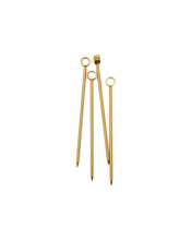 Load image into Gallery viewer, Four of &quot;The Owen Cocktail Picks in Gold&quot; are artfully arranged diagonally against a white background. Each pick features a pointed end and a circular loop at the top, with one pick showcasing a small rectangular accent near the loop. These glossy, metallic stainless steel picks beautifully reflect light.
