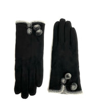 Load image into Gallery viewer, The Micro-suede Glove with Faux Fur Interior is beautifully presented against a white background, featuring two sophisticated black gloves. Each glove is decorated with grey pom poms near the wrist and has faux fur trim accentuating the cuffs. Ideal for cold weather, the left glove prominently highlights its stylish design.
