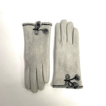 Load image into Gallery viewer, A pair of Micro-suede Gloves with Faux Fur Interior is elegantly displayed on a white surface. Embellished with small pom-poms and trimmed with dark gray borders, these gloves feature faux fur accents near the wrists. The left glove rests palm down while the right showcases its palm facing out, highlighting their stylish design.
