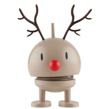 Load image into Gallery viewer, The Hoptimist Reindeer Bumble is a beige, round figure featuring a red nose and brown antlers, making it ideal for festive Christmas decorations. This toy includes simple eyes and stands on stout legs with flat feet. Its minimalist design incorporates a spring-like section, giving it a playful, bouncy charm.
