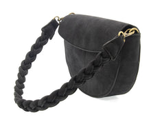 Load image into Gallery viewer, Displaying the Luna Crescent Crossbody with Braided Handle, this chic black vegan suede handbag showcases a flap closure and features a thick braided shoulder strap secured by brass hardware. Its half-moon design offers a structured, rounded shape that delivers both modern style and elegance.
