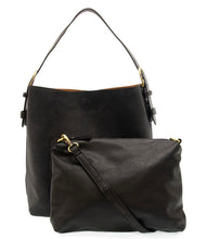 Load image into Gallery viewer, Shown are two black leather handbags from the Hobo 2 in 1 Faux Suede Handbag collection. The larger bag, crafted from vegan leather, features a single shoulder strap and a minimalist design with subtle stitching. In front of it is the smaller clutch, which includes a removable crossbody strap. Both bags are adorned with gold-tone hardware accents.
