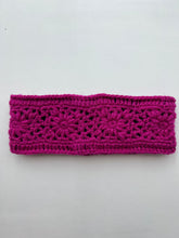 Load image into Gallery viewer, Displayed on a plain white background is a Wool Knit Headband, handmade in bright magenta from soft sheep wool in Nepal. The design showcases intricate floral patterns and textured stitches, offering a decorative and stylish appearance.
