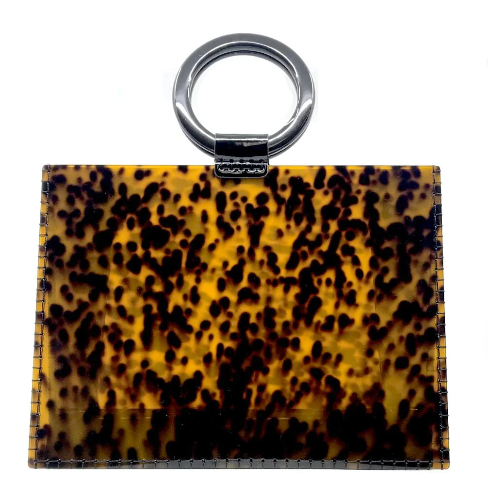 A stylish and classic accessory, the Resin Valet Bag Keychain boasts a glossy finish with a rectangular shape in shades of brown and yellow tortoiseshell pattern. It is equipped with a silver metal ring attached at the top by a black leather loop, making it easy to attach to keys or bags—ideal for adding a touch of sophistication to your tote bag.