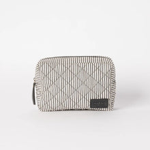 Load image into Gallery viewer, The Bella Pouch - Cotton/Black Classic Leather is a small, rectangular pouch flaunting a black and white striped pattern. Made from recycled cotton, it boasts a padded quilted design with diamond shapes. Positioned on a plain white background, its sustainable appeal is enhanced by a black label with stitching detail prominently displayed on the front lower right corner.
