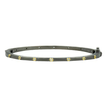 Load image into Gallery viewer, The Thin Bezel Stacking Bangle is a sleek black metal bracelet with a rhodium matte finish, featuring small cubic zirconia stones set in 14K gold bezels at evenly spaced intervals. It includes an adjustable clasp on one end, presenting a minimalist and elegant design.
