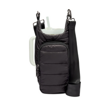 Load image into Gallery viewer, The HydroBag Handle is a black, quilted, insulated cup carrier equipped with a crossbody strap. It securely holds a large tumbler with a straw and includes an elastic straw holder for added convenience. The adjustable straps and durable metal clasps ensure effortless transport.
