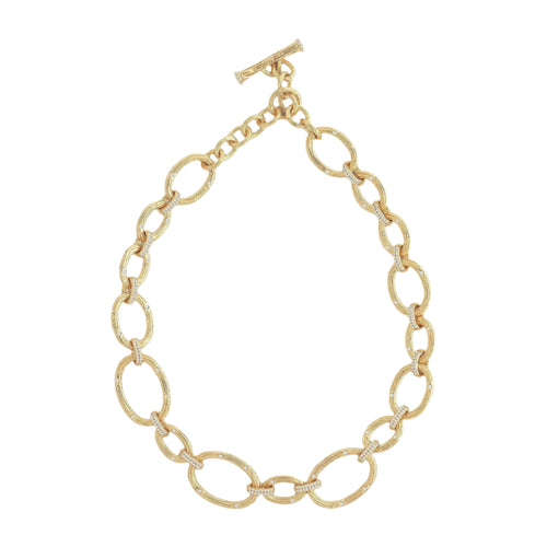 Introducing the Enchanted Forest Chain Necklace, a luxurious piece crafted from 18k gold, featuring large oval links with a textured surface. This elegant necklace is fastened with a toggle clasp and beautifully displayed on a plain, light background.