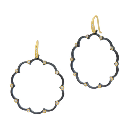 Introducing the Signature Brooklyn in Bloom Open Hoop Earrings: A pair of elegant hoop earrings featuring a scalloped edge design. Each earring is embellished with small diamond accents at each curve, set against a dark metallic finish. The gold-toned hooks add a striking contrast, enhancing their modern and sophisticated appearance.