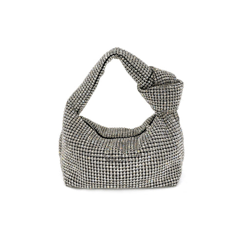 The Rhinestone Monroe Bag, a silver evening accessory, showcases sparkling rhinestones and a knotted handle with a soft, slouched structure set against a white background. Its surface is entirely adorned with evenly placed round crystals, exuding ultimate glamour and offering a textured appearance.