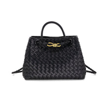 Load image into Gallery viewer, The image showcases the Talene Crossbody Bag, a black woven leather handbag with a structured design. It includes a short handle, gold-toned hardware, an intricate knot detail on the front, and a magnetic closure for added convenience. The bag exudes sophistication and timeless style.
