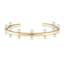 Load image into Gallery viewer, The Cindy Studded Cuff is a hypoallergenic, open-ended bracelet featuring evenly spaced silver spheres along its outer edge. Its polished 18k gold-plated surface contrasts beautifully with the shiny silver spheres, resulting in a modern and elegant design.
