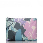 Load image into Gallery viewer, The Aloha Pouches are rectangular toiletry pouches with zippers, ideal for flights. They boast a floral pattern featuring large pink, purple, and blue flowers against a dark gray background. The brand logo is in the bottom left corner, making them a stylish and organized travel companion.
