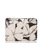 Load image into Gallery viewer, The Aloha Pouches laptop sleeve showcases a striking black and white floral design with large black flowers and leaves on a cream background. Its rounded corners and top black zipper make it the perfect travel organizer for your carry-on.
