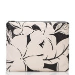 Load image into Gallery viewer, The Aloha Pouches boast a beige clutch adorned with bold black floral prints, featuring large abstract flowers and leaves that create a striking contrast. Ideal for beach essentials, its zippered top keeps everything organized and secure.
