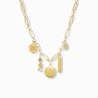 Load image into Gallery viewer, The Multi-Charm Link Necklace features gold-plated, large oval chain links adorned with various charms: a circular pendant, a rectangular bar, a textured disk with cut-out design, and three additional small decorative pieces, all set against a plain white background.
