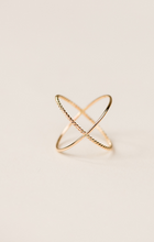 Load image into Gallery viewer, Introducing the Braided X Ring, a handcrafted minimalist piece featuring intersecting 14k gold-filled bands with a delicate, textured pattern. Its elegant design is highlighted against a soft, neutral background for a simple yet sophisticated aesthetic.
