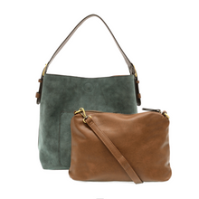 Load image into Gallery viewer, The Hobo 2 in 1 Faux Suede Handbag, showcasing an elegant green faux suede design, features a stylish brown vegan leather handle. It comes with a complimentary smaller brown removable crossbody bag. The tote is adorned with a visible pocket and gold hardware, while the crossbody bag stands out with a gold zipper against a crisp white background.
