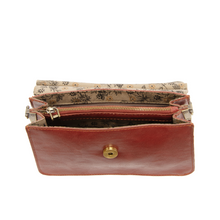 Load image into Gallery viewer, Aria Ring Bag - Fall/Winter in open brown vegan leather, featuring a gold button clasp, displayed against a white background. The interior showcases multiple compartments with a zippered pocket and is lined in beige and black floral-patterned fabric.
