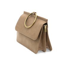 Load image into Gallery viewer, Introducing the Aria Ring Bag - Fall/Winter: A fashionable taupe handbag featuring a large brass ring handle and a flap closure, evoking the style of a bracelet bag. Its structured, rectangular design is crafted from smooth vegan leather. The side view reveals a roomy interior with a zipper, complemented by the elegance of a detachable shoulder strap for added practicality.
