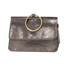 Load image into Gallery viewer, Presenting the Aria Ring Bag - Fall/Winter: a sophisticated bracelet bag in metallic silver with a glossy finish. This chic accessory is crafted from vegan leather and features a prominent gold ring handle adorning the front flap. Its rectangular silhouette showcases clean lines and a structured form, seamlessly merging contemporary design with sustainable fashion.
