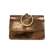 Load image into Gallery viewer, Introducing the Aria Ring Bag - Fall/Winter, a compact and elegant accessory crafted from smooth vegan leather in a shimmering metallic bronze hue. This versatile bracelet bag showcases clean, minimalistic lines and is adorned with a striking large circular gold ring on the front flap, serving as both an eye-catching decorative feature and a functional handle.
